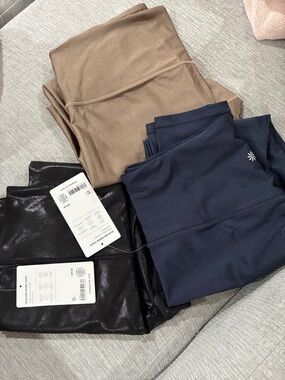 3 pairs Athleta Elation Sheen Tight Leggings in Navy, black and brown